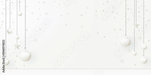 Silver Christmas ornaments hanging against a soft white background, with copy space for design