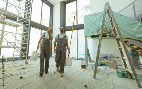 Workers with paint buckets ...