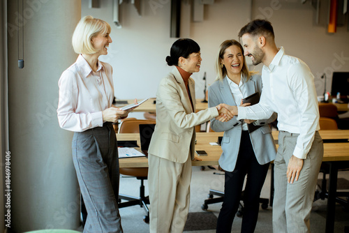 Business people shake hands...