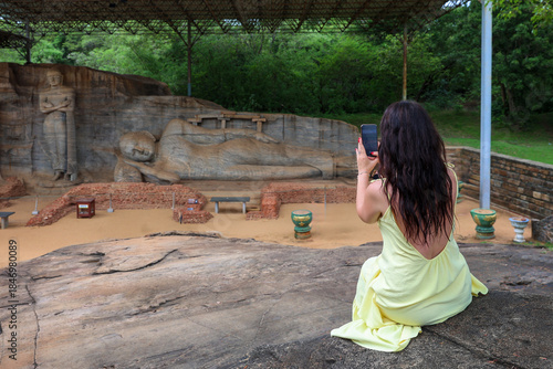 Quadro em tela Woman photographing the majestic Reclining Buddha at Gal Vihara, Sri Lanka