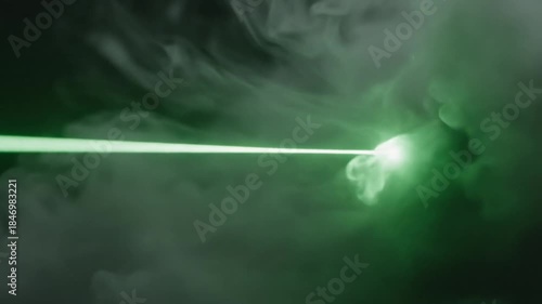 Vibrant Green Laser Beam Penetrates Wispy Smoke Plume Against Dark Background Dramatic SciFi Energy Burst