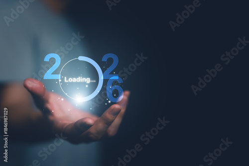 Human hand holding a glowing digital loading interface transitioning into 2026, symbolizing future readiness, technology progress, innovation, new year transformation, and digital evolution concept.
