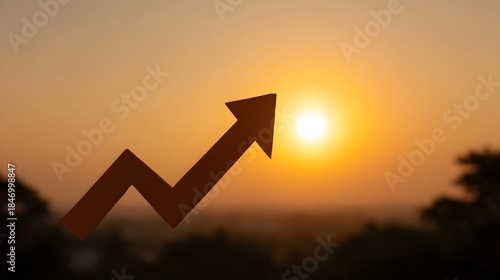 A growing arrow silhouette set against a warm golden hour sunrise sky symbolizing success and positive trends