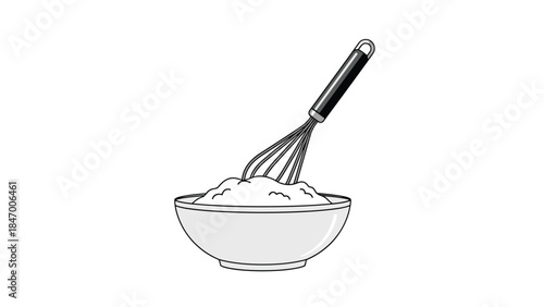 Whisking ingredients in a bowl suggests baking or cooking preparation, showcasing a common kitchen scene and culinary activity.