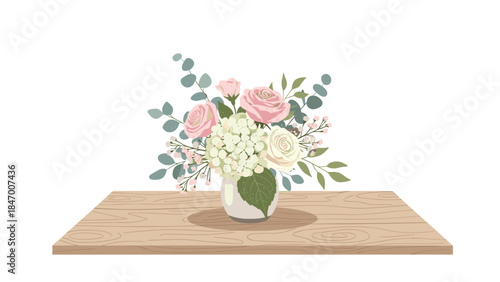 Delicate floral arrangement in a glass vase sits atop a light wood surface, creating a soft and elegant display.
