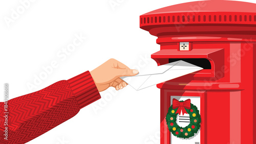A hand is shown mailing a white letter into a bright red traditional pillar mailbox decorated with a festive holiday wreath.