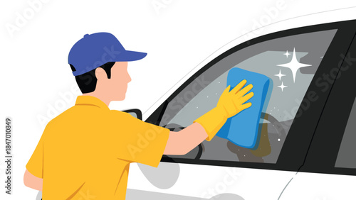 A person wearing gloves and a cap is diligently cleaning a car window, ensuring a spotless and clear view for drivers.