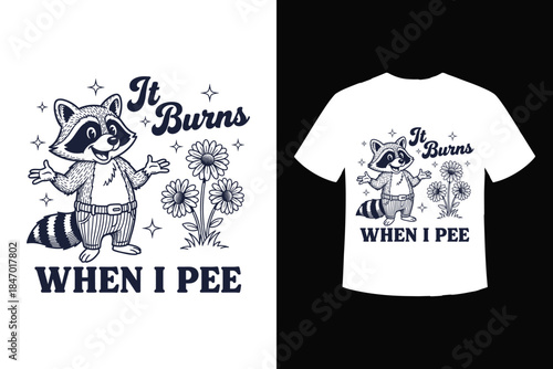 A humorous vintage raccoon t-shirt design featuring the quote 'it burns when i pee'