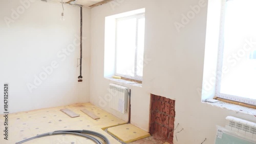 Empty living room after putty work on walls and ceiling in new build house. total reconstruction of old apartment, changing house. drywall gypsum. Process of gradual renovation of premise. Home