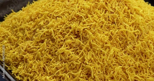 Besan Sev or Indian Namkeen Noodles of chickpea flour. Popular Gujarati Deep fried Teatime Snack.