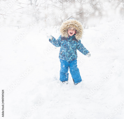 A child is playing outside in the snow.
