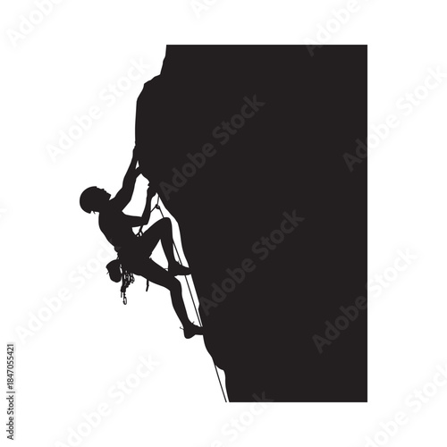 Silhouette of a rock climber scaling a steep dark cliff face