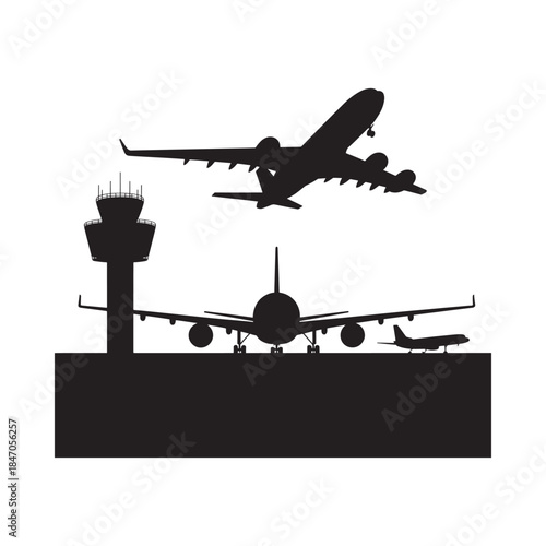 Silhouetted airplanes taking off and landing near an airport control tower