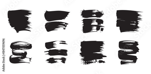 Set of isolated black paint strokes and ink splatters on a white background