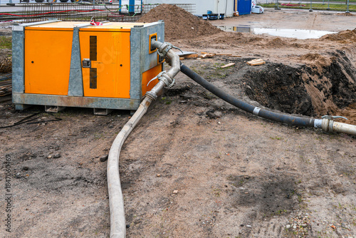 Construction site dewatering pump system removing groundwater from excavation area