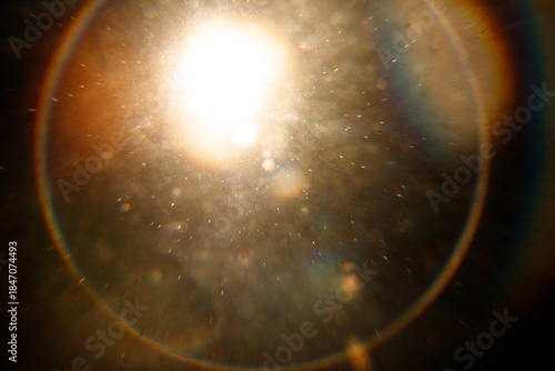 Lens Flare. Light over black background. Easy to add overlay or screen filter over photos. Abstract sun burst with digital lens flare background. Gleams rounded and hexagonal shapes, rainbow halo. big