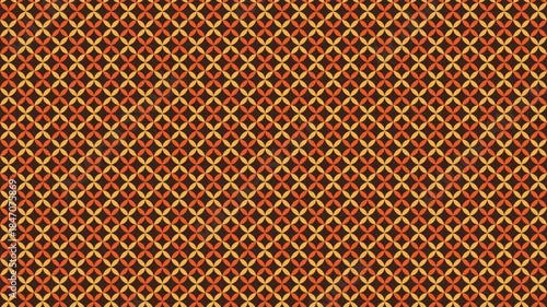 Repeating pattern of orange and yellow floral shapes on brown