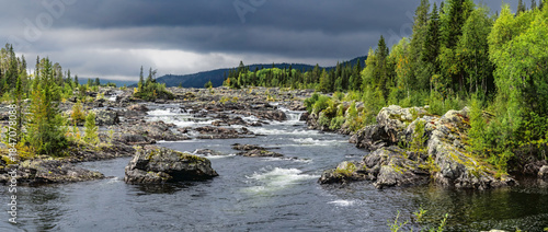 Rushing river flowing through Swedish Lapland rocky landscape