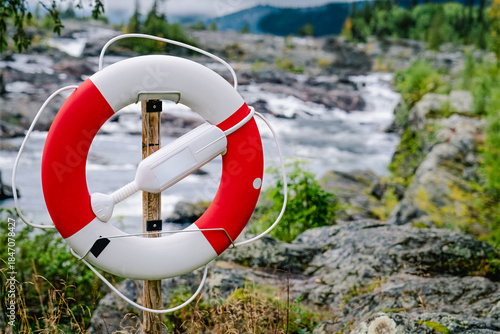 Lifebuoy standing by river rapids in Sweden Lapland