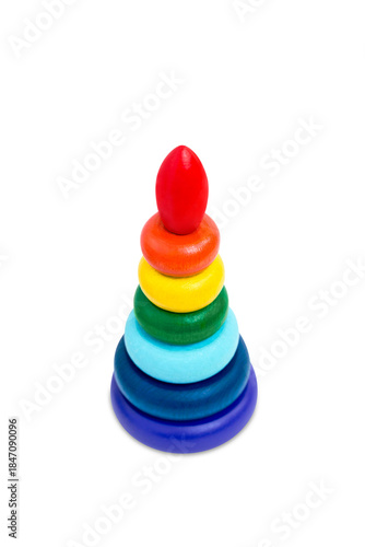 Multicolored wooden toy pyramid on white background. Toy, build from colored wooden rings. Kids educational toy set, colorful blocks