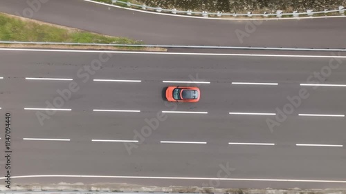 Drone shot of Car moving on Empty road. Race track droe shot.