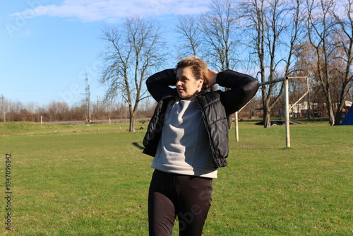 Woman doing morning exercises on an outdoor sports ground