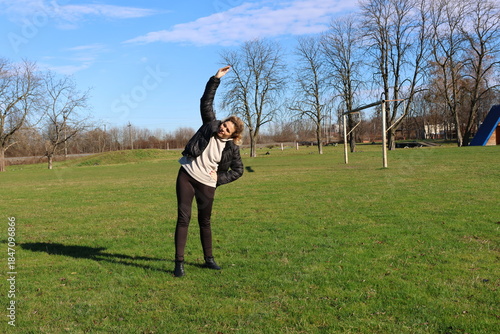 Woman doing morning exercises on an outdoor sports ground
