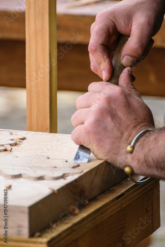 Cuadro en lienzo Woodworker using a gouge to shape a piece of wood The Concept of tradition and skill