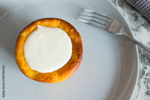 Delicious cheesecake with sour cream on a plate. Breakfast concept for the family