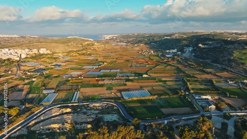 Drone view of countryside agriculture fields and popular sand beach. Malta island