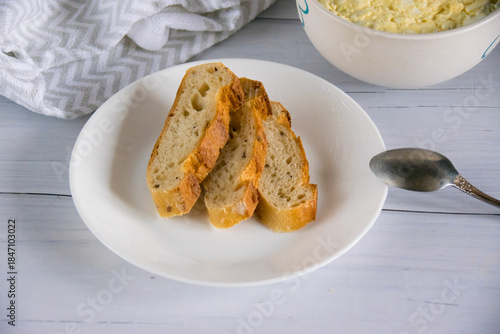 Whole grain baguette made from buckwheat flour and sesame seeds, and salad with egg