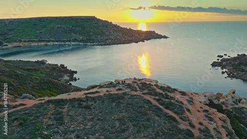 Drone view of famous sunset point on Ghain Tuffieha beach, rocks. Mediterranean sea, Maltese island