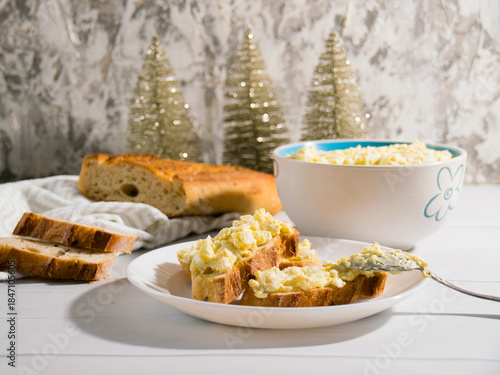 The process of preparing for the Christmas and New Year holidays. Making sandwiches with baguette, processed cheese and egg