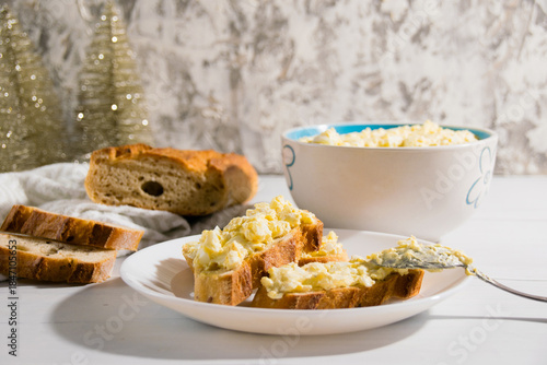 The process of preparing for the Christmas and New Year holidays. Making sandwiches with baguette, processed cheese and egg