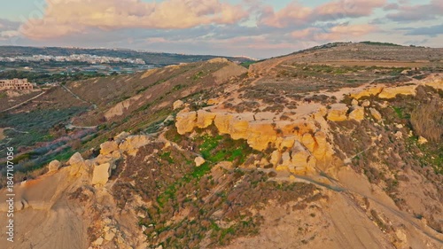 Drone view of famous sunset point on Ghain Tuffieha beach, rocks. Mediterranean sea, Malta