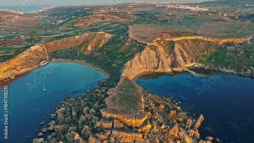 Drone  sunset view of Ghain Tuffieha beach, rocks, hills. Mediterranean sea, Malta island