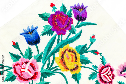 Colorful floral embroidery on cotton fabric with floral patterns on a white background.