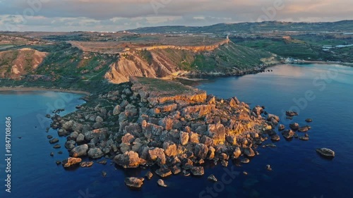 Drone  sunset view of Ghain Tuffieha beach, rocks, hills. Mediterranean sea, Maltese island