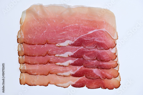 slices of smoked ham on a white background close-up