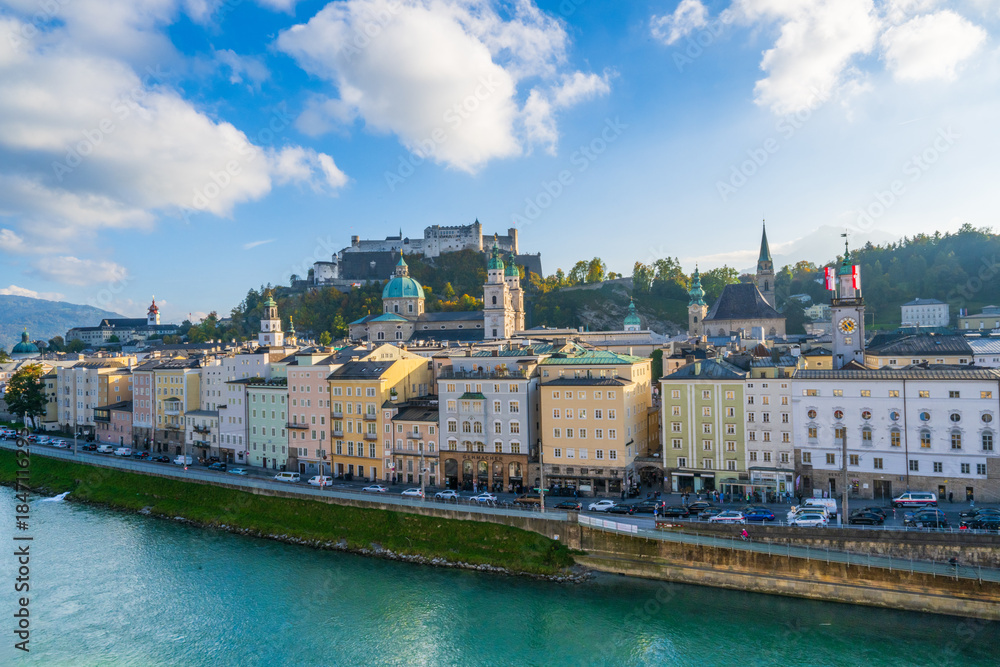 Naklejka premium City of Salzburg with Salzach River and Fortress Hochensalzburg in the fall season.