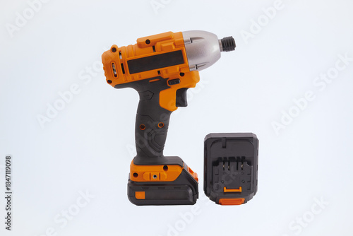 Cordless impact screwdriver with extra battery on a white background