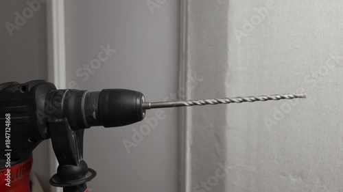 A drill or screwdriver in operation close-up. Electrical appliance being repaired.