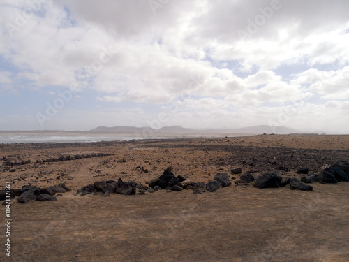 El Cotillo village - Fuerteventura island - Spain - December 4 2025 : Dramatic view of beautiful desert landscape, rugged coastline, beach and Atlantic Ocean.
