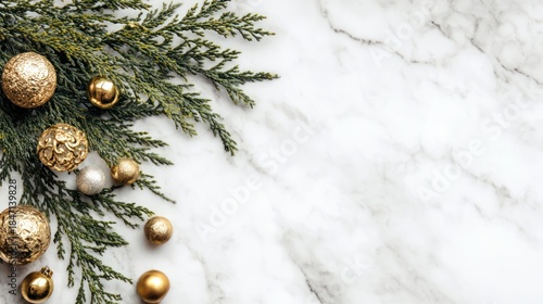 Fir tree branches and golden Christmas decorations on white marble background, flat lay, copy space