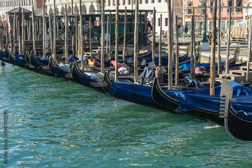 Traditional gondolas docked along a canal in Venice, Italy