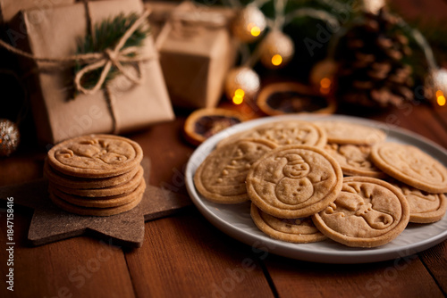 Christmas table with butter cookies with cinnamon and decorations, evening atmosphere