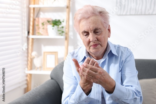 Wallpaper Mural Senior woman suffering from pain in palm at home. Rheumatism symptom Torontodigital.ca