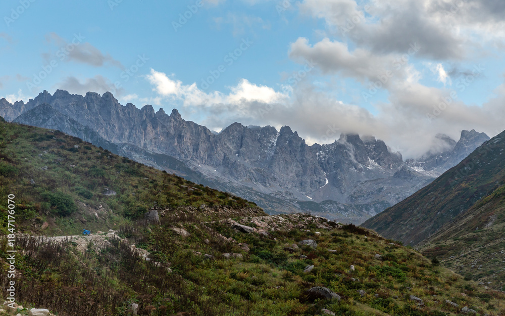 Obraz premium Altıparmak Mountain, a continuation of the Kaçkar Mountains, and a flock of sheep grazing in the tents in the valley...