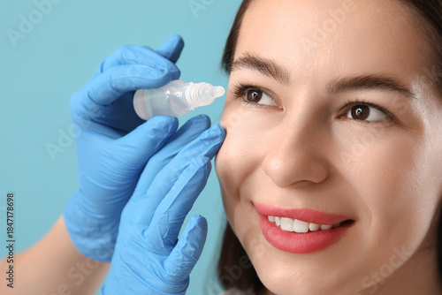 Doctor's hands with eye dro...