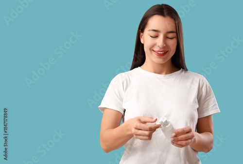 Young woman with eye drops ...